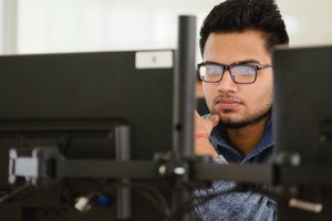 programming student working on a computer